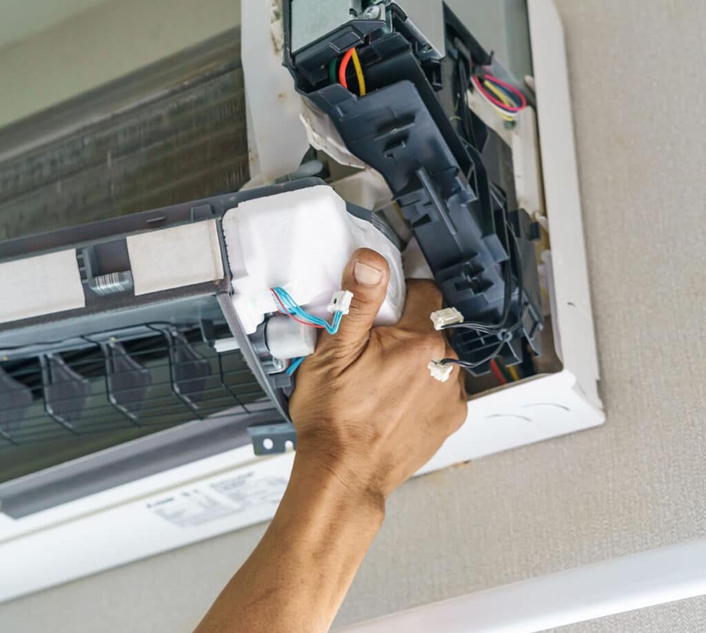 service technician is cleaning, repair and maintenance of air conditioner