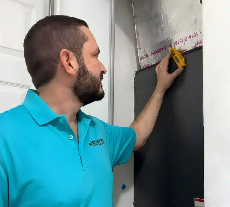Quick Fix Air Repair technician checking air-conditioning system measurements